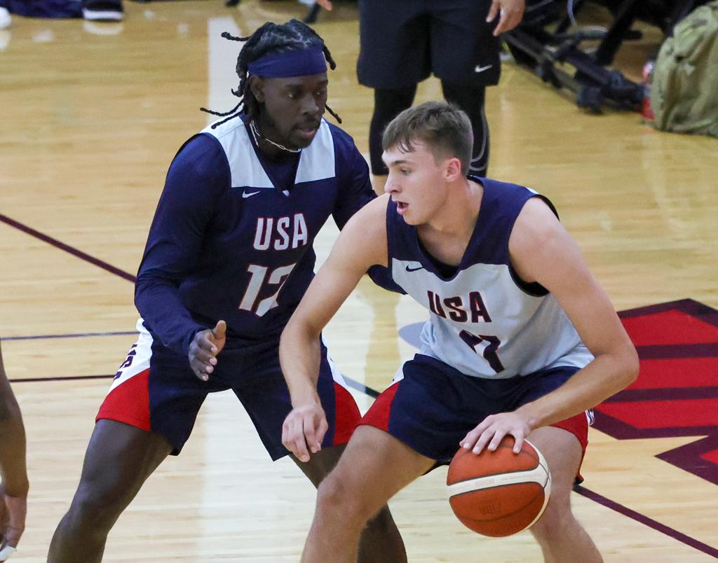 Cooper Flagg #31 of the 2024 USA Basketball Men's Select Team being guarded by Jrue Holiday #12 during a practice session scrimmage in Las Vegas, Nevada