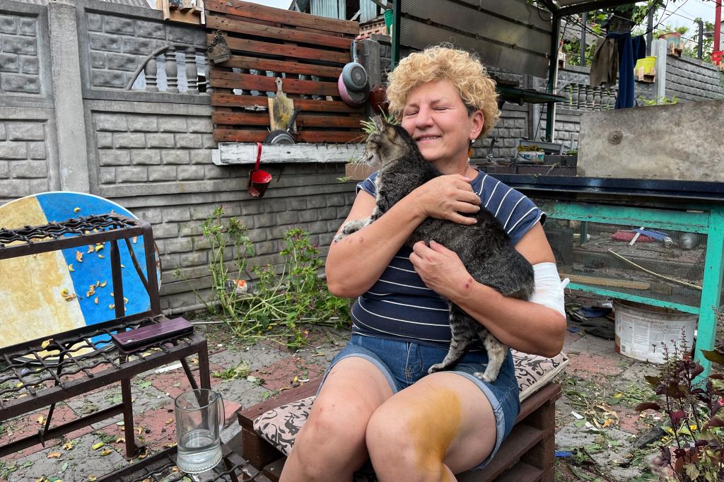 A Ukrainian and her cat who survived Russian attacks.