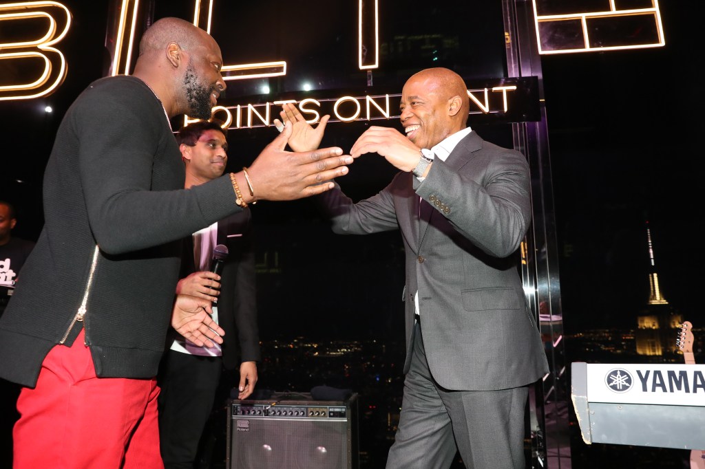 Wyclef Jean, Ankur Jain, and Mayor Eric Adams attending the Bilt Rewards X Wells Fargo Launch Event Party in New York City, clapping their hands