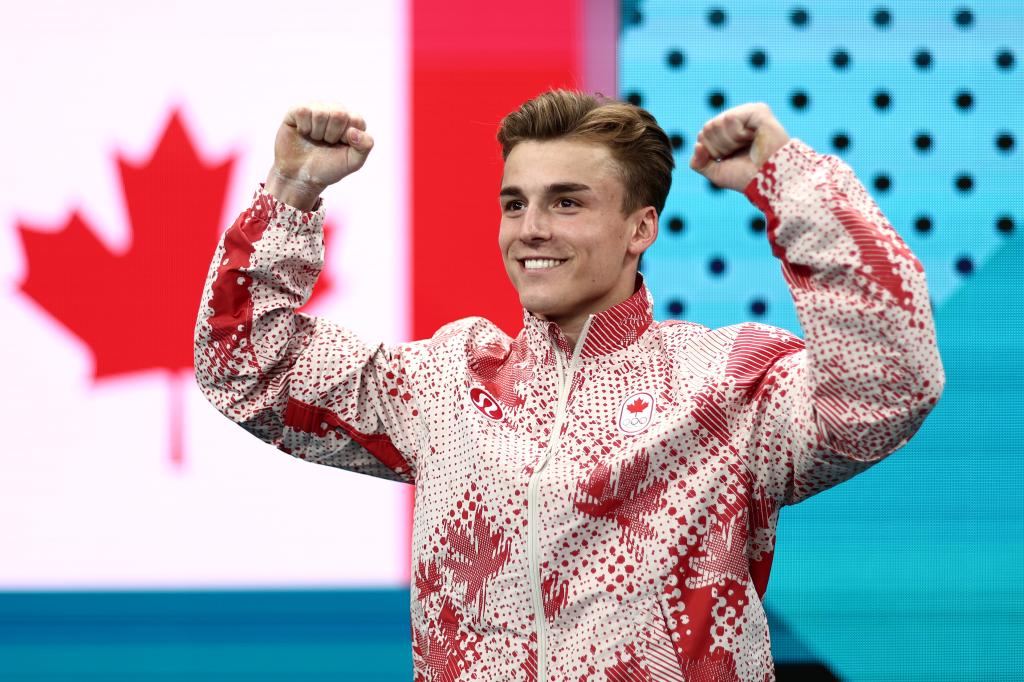 Felix Dolci of Team Canada entering the Bercy Arena for the Artistic Gymnastics Men's All-Around Final at the Olympic Games Paris 2024, arms raised in emotion.