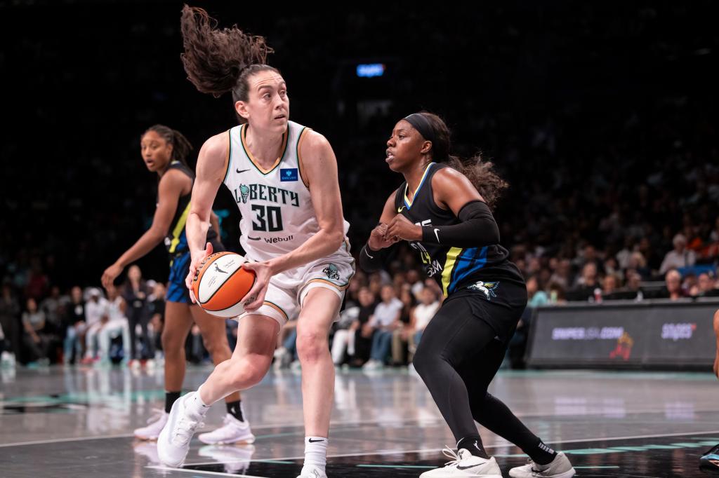 Breanna Stewart #30 of the New York Liberty playing basketball against Arike Ogunbowale #24 of the Dallas Wings at Barclays Center