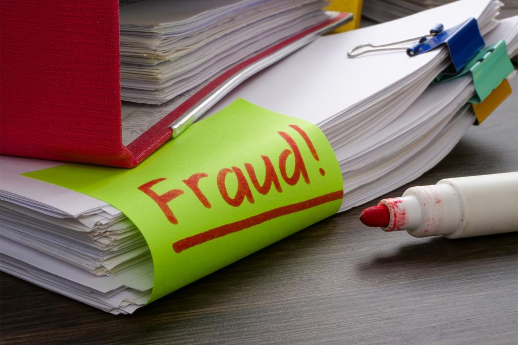 A stack of papers with a green fraud note on top