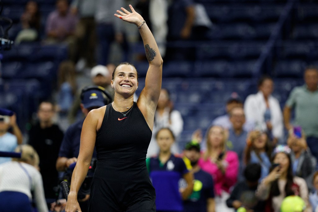 Aryna Sabalenka celebrates and waves to the remaining crowd after her three-set victory over Ekaterina Alexandrova early Saturday morning on Aug. 31, 2024.