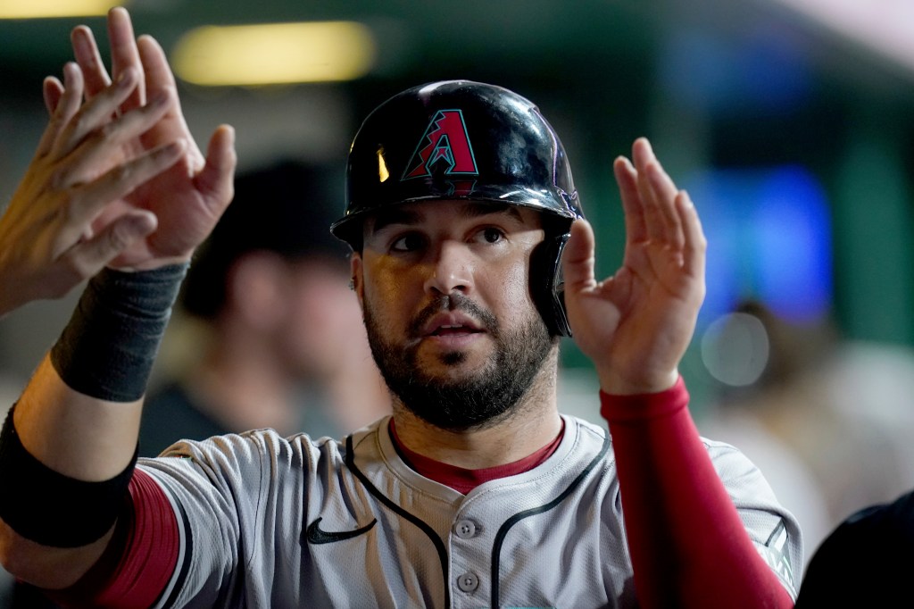 Arizona Diamondbacks' Eugenio Suarez celebrates in the dugout after scoring during the fifth inning of a baseball game against the Pittsburgh Pirates Saturday, Aug. 3, 2024, in Pittsburgh.