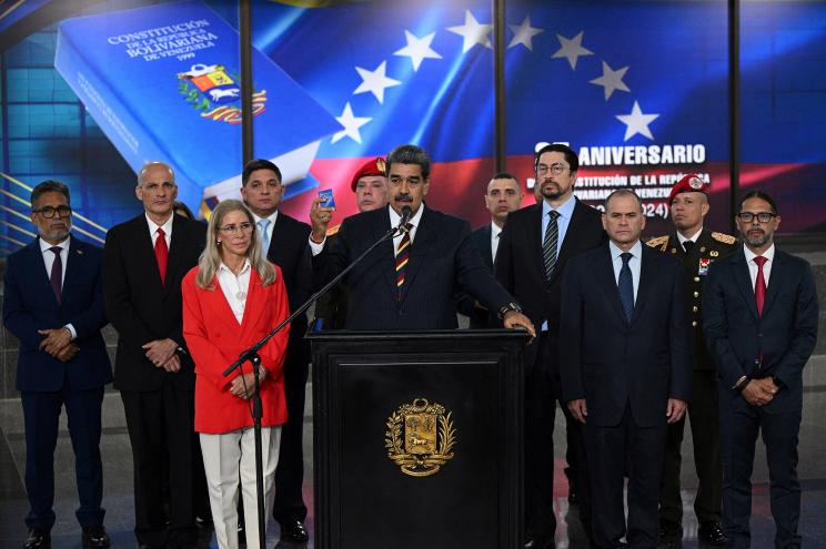 Venezuela's President Nicolas Maduro (C) addresses the media next to his wife Cilia Flores after appearing before the Supreme Court of Justice (TSJ) in Caracas on August 9, 2024.