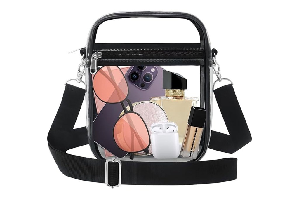A clear crossbody bag containing a variety of items