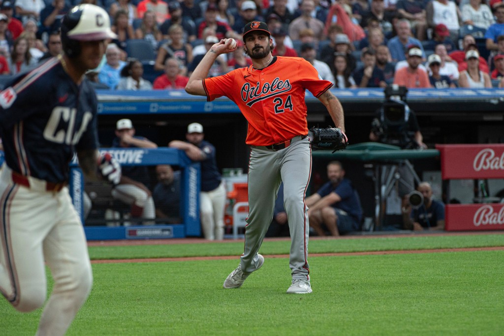 Baltimore Orioles starting pitcher Zach Eflin (24) throws out Cleveland Guardians' Brayan Rocchio, left, at first base during the third inning of a baseball game in Cleveland, Saturday, Aug. 3, 2024. 