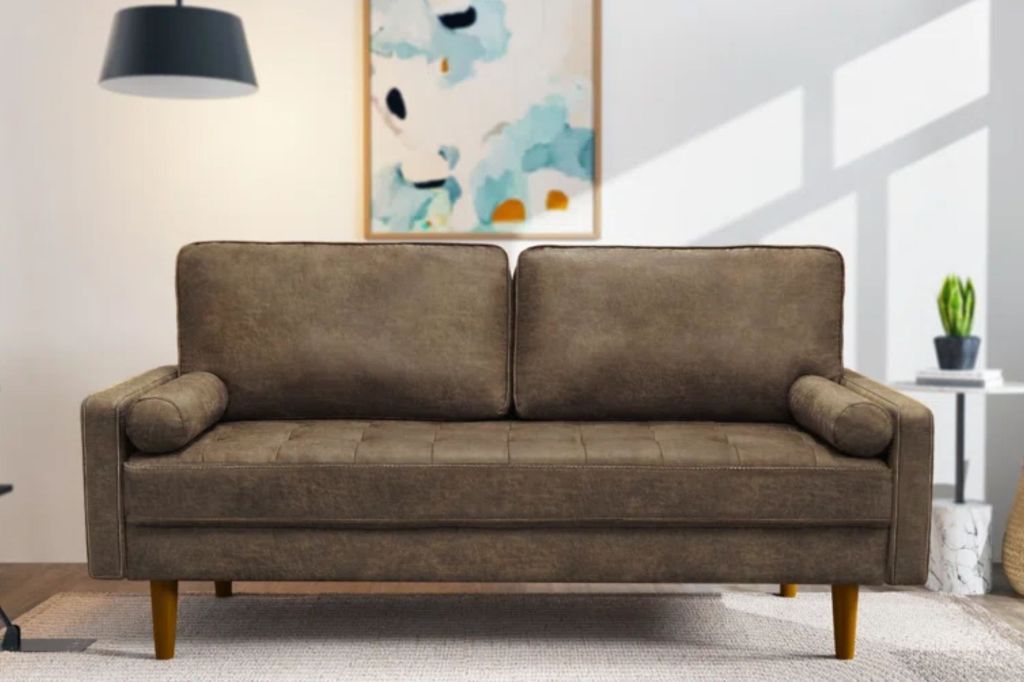 A olive green 3-seat vegan leather sofa.