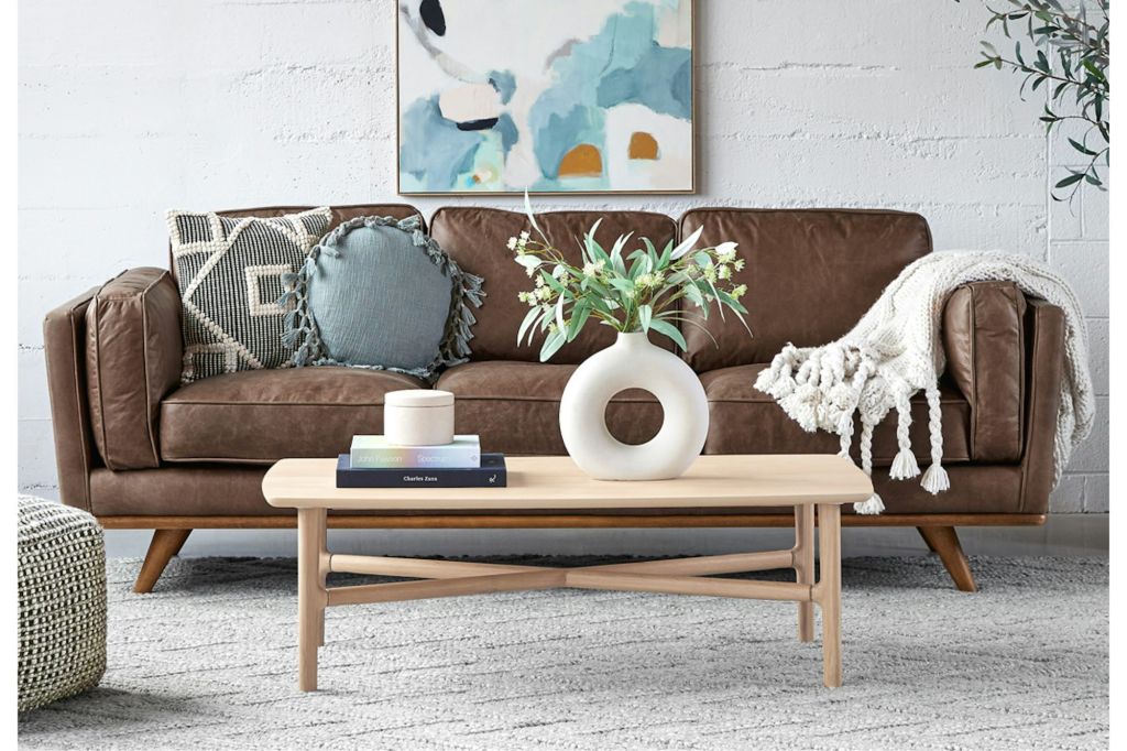 A dark brown leather couch in a modern living room.