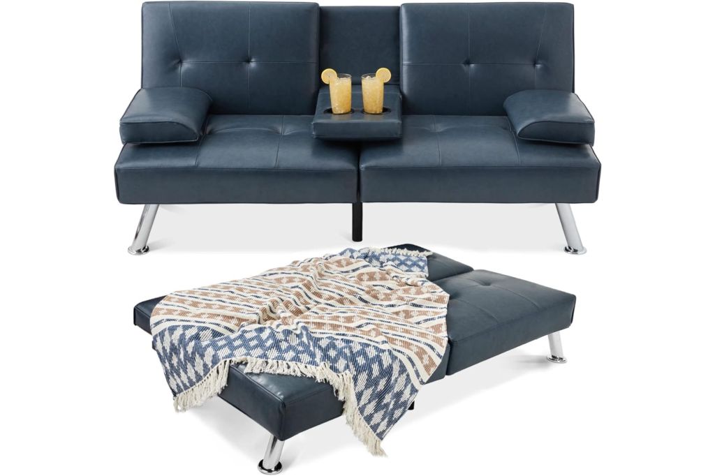 A navy blue leather couch with cup holders with juice in the center, and the couch opened into a flat bed.