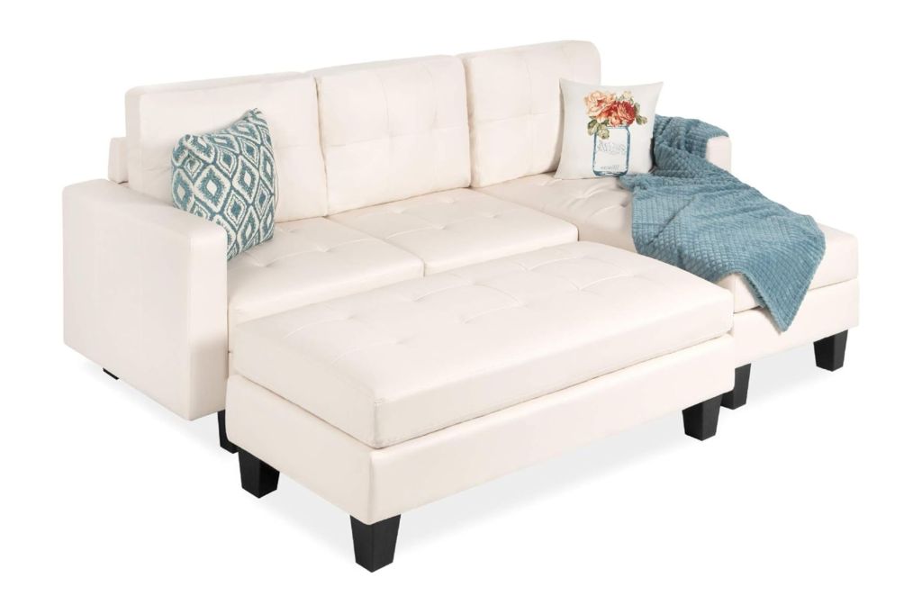 A white leather sectional with an ottoman 