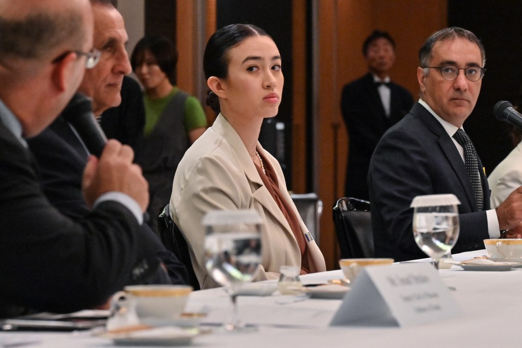 Noa Argamani, a woman rescued after abduction from Nova music festival, sitting at a table during a meeting with G7 embassy representatives in Tokyo