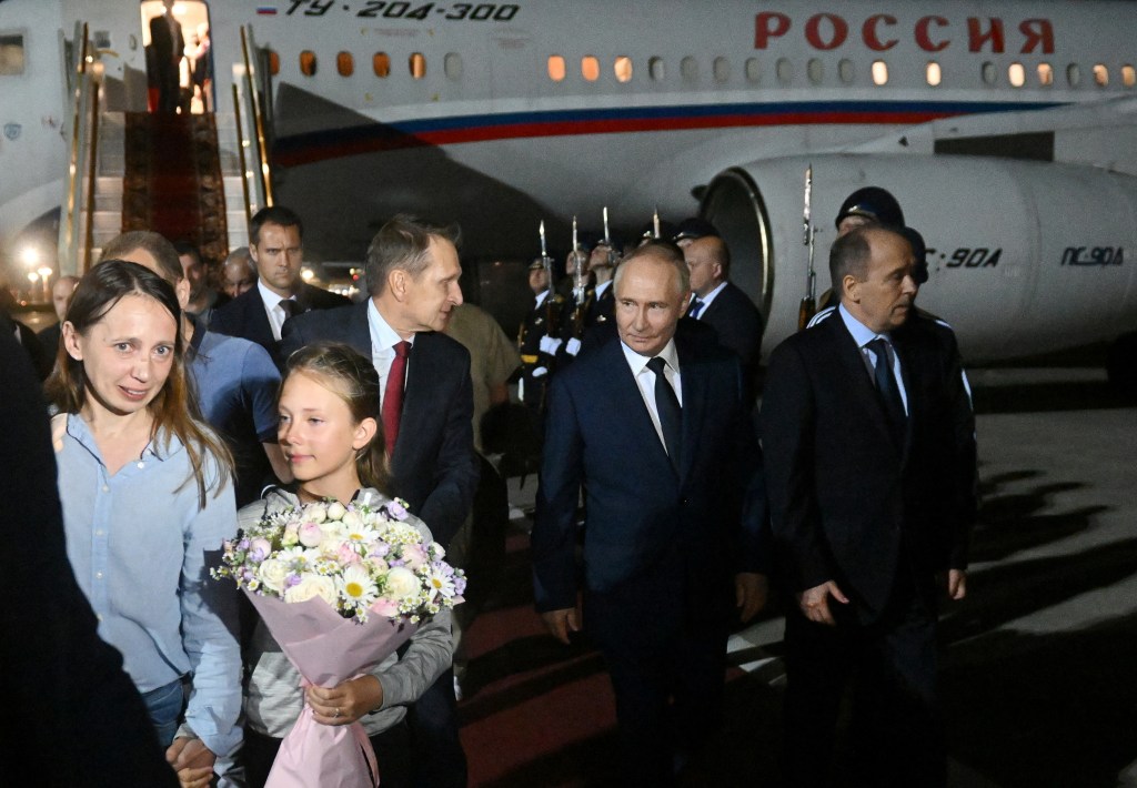 Russia's President Vladimir Putin, Director of the Federal Security Service (FSB) Alexander Bortnikov and Foreign Intelligence Service (SVR) Director Sergey Naryshkin welcome Russian nationals, who were released in a prisoner exchange between Russia with Western countries