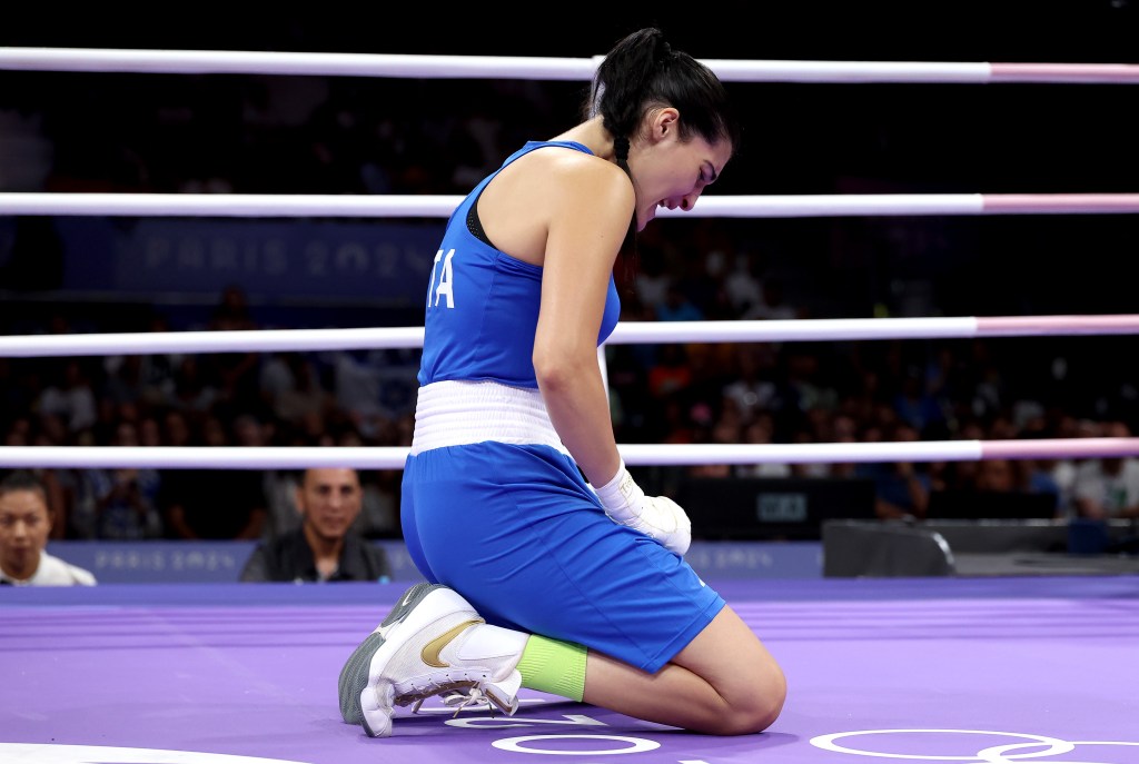 Angela Carini of Team Italy reacts after abandoning the Women's 66kg preliminary round match against Imane Khelif of Team Algeria.