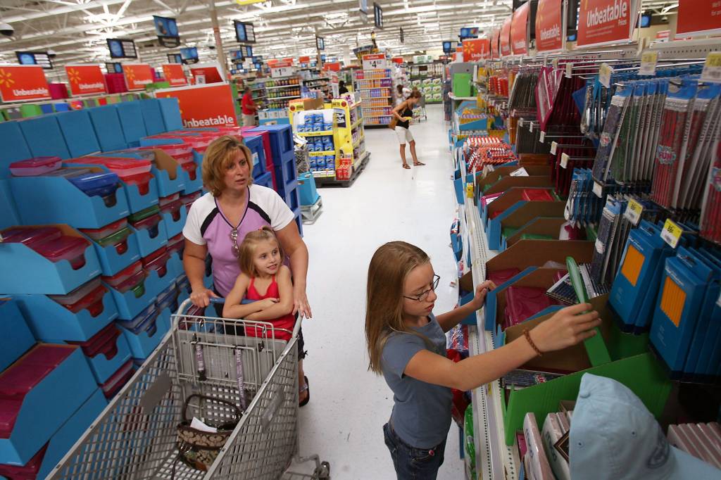 Mother and daughters shopping for Back to School supplies at Walmart.