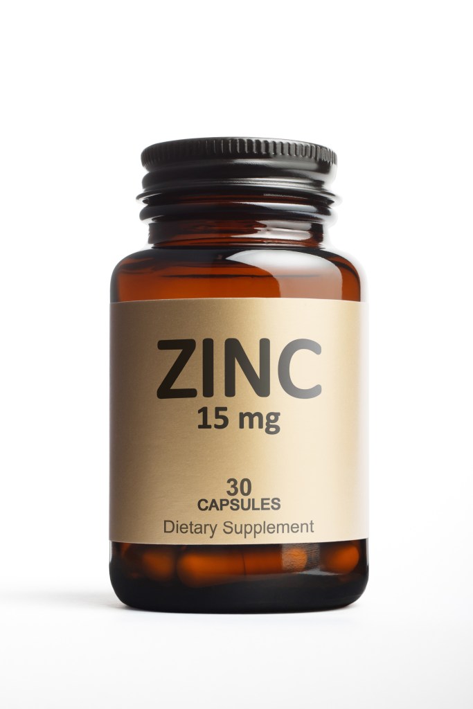 Bottle of Zinc supplement capsules isolated on a white background