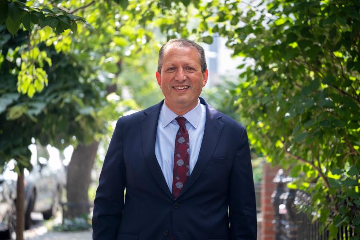 Brad Lander standing in front of trees