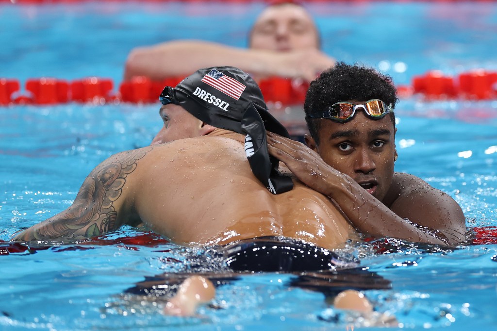 Caeleb Dressel of Team United States and Josh Liendo of Team Canada embrace after the Men's 100m Butterfly Semifinals on day seven of the Olympic Games Paris 2024.