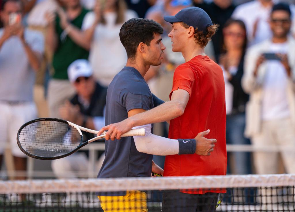 Carlos Alcaraz of Spain and Jannik Sinner of Italy embracing after their match on day 13 of the French Open at Stade Roland Garros, Paris, France.