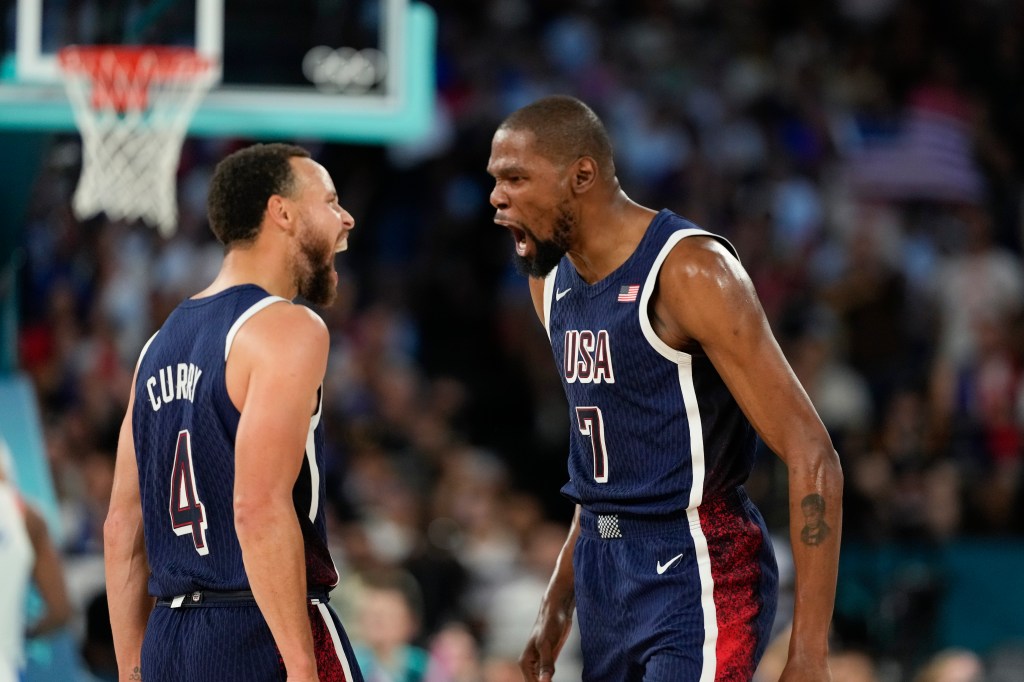 United States' Kevin Durant (7) celebrates with teammate Steph Curry after scoring a basket against France during a men's gold medal basketball game at Bercy Arena at the 2024 Summer Olympics, Saturday, Aug. 10, 2024, in Paris, France.