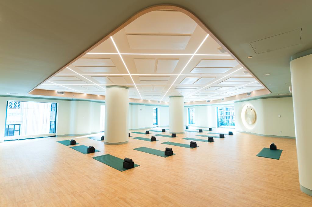 Large fitness room with mats and a large window at Chelsea Piers Fitness Flatiron