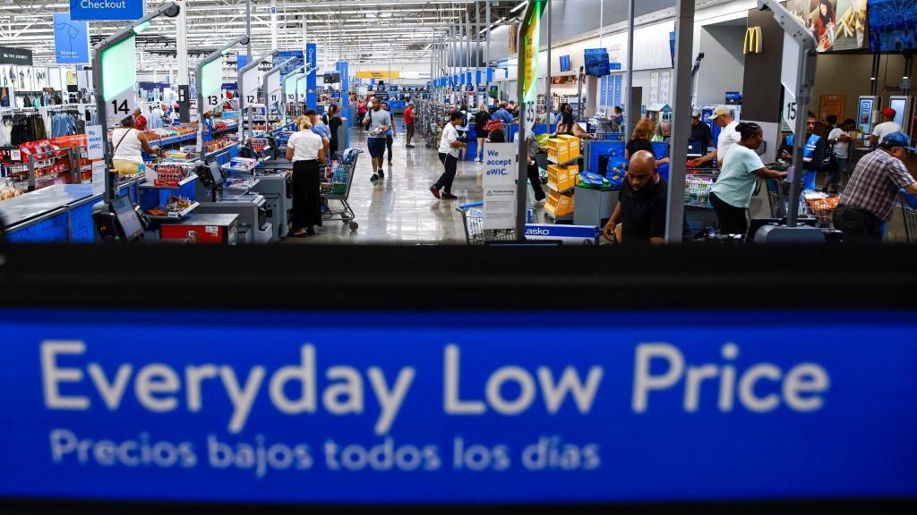 Customers using self-checkout at a Walmart Superstore in Secaucus, New Jersey on July 11, 2024 near an "Everyday Low Price" sign.