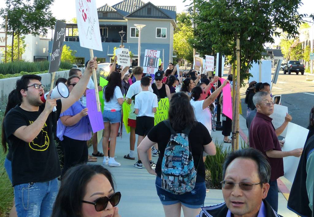 A group of people holding signs, rallying in front of Shasta County Superior Court on July 5, 2024, advocating for missing person Nikki Cheng Saelee McCain, with Alfred Sit and Takaharu Furukawa present.