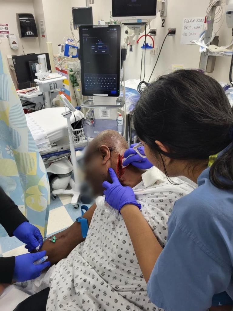 A photo of Alton Scott, a veteran MTA conductor, receiving stitches after being slashed.