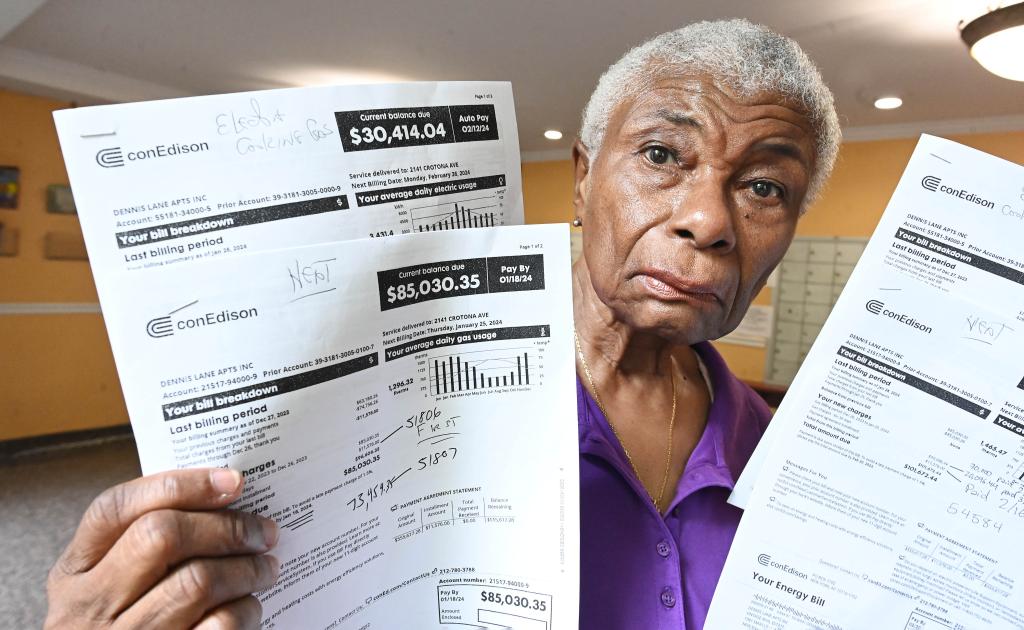 Wardean D. Squire-Askew holds some of the co-op's Con Edison bills at the Dennis Lane Apartments in the Fremont Katonah section of the Bronx