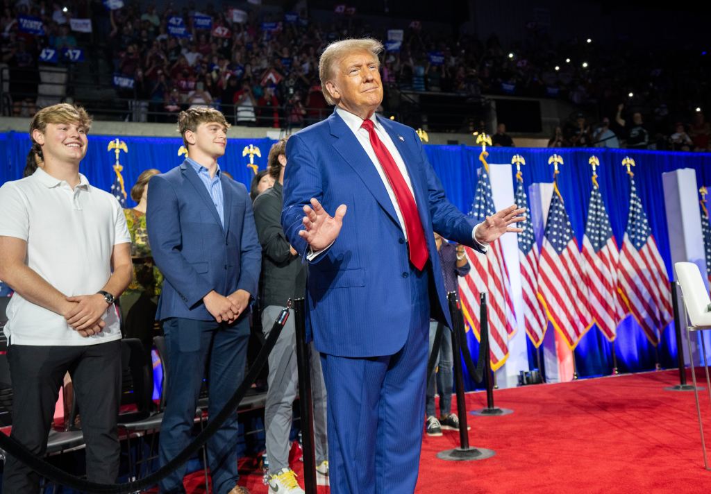 Donald Trump enters for a town hall event hosted by Tulsi Gabbard at the La Crosse Center.