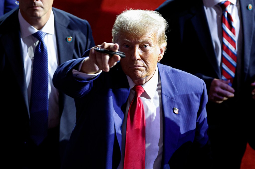 Donald Trump points to the crowd as he leaves after speaking during a town hall meeting in La Crosse, Wisconsin, on August 29, 2024.