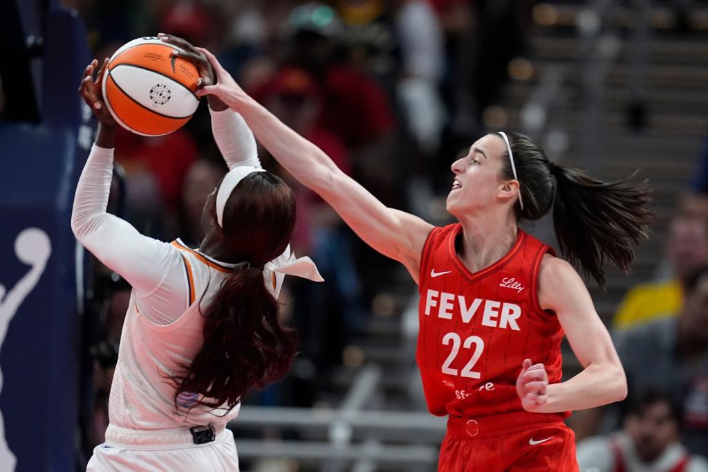 Phoenix Mercury's Kahleah Copper (2) is fouled by Indiana Fever's Caitlin Clark (22) during the second half of a WNBA basketball game on Aug. 16, 2024.