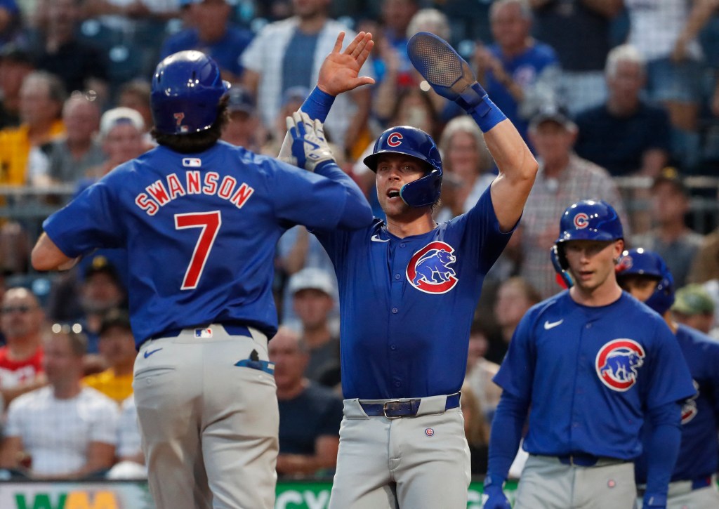 Chicago Cubs second baseman Nico Hoerner (middle) greets shortstop Dansby Swanson (7) crossing home plate on a two run home run against the Pittsburgh Pirates during the fourth inning at PNC Park on August 27, 2024. 