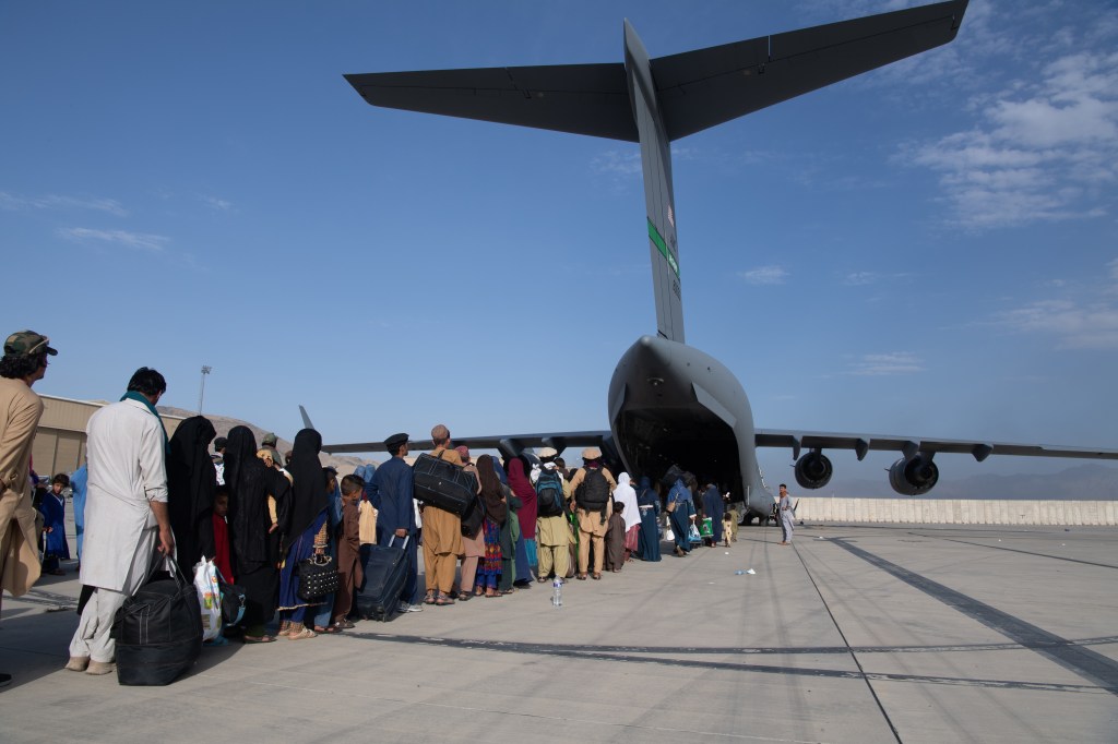 Air Force loadmasters and pilots assigned to the 816th Expeditionary Airlift Squadron, load passengers aboard a U.S. Air Force C-17 Globemaster III in support of the Afghanistan evacuation at Hamid Karzai International Airport (HKIA) on August 24, 2021 in Kabul, Afghanistan.