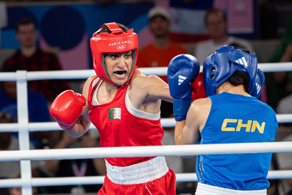 Imane Khelif of Algeria punching Liu Yang of China during the Women's 66kg final match at the 2024 Olympic Games in Paris, France.