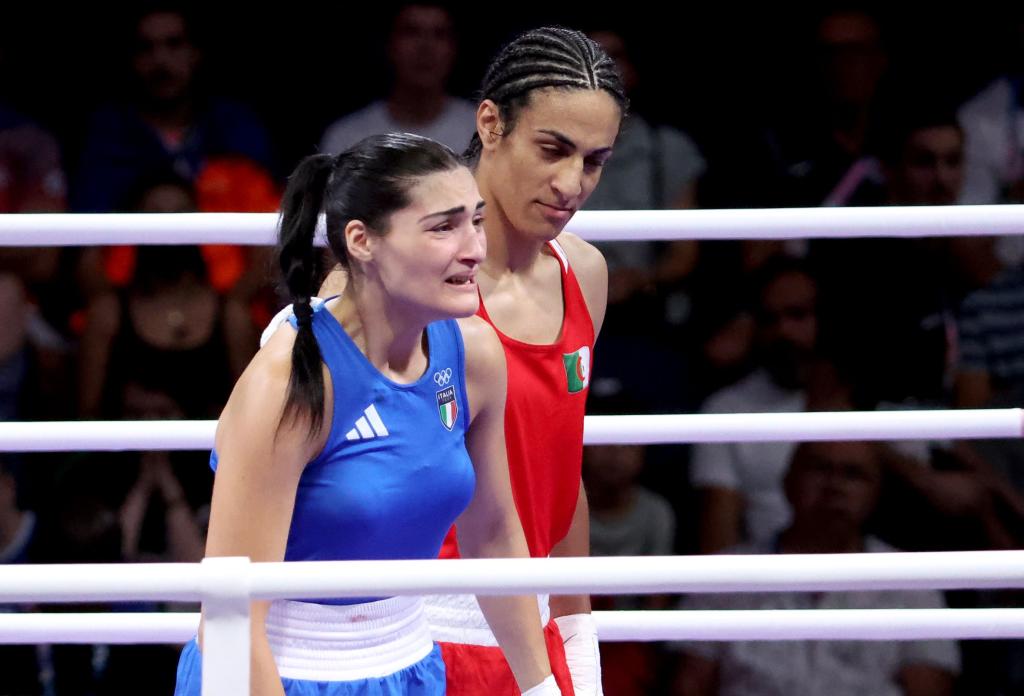 Angela Carini (L) of Italy abandons her bout in the Women 66kg preliminaries round of 16 against Imane Khelif.