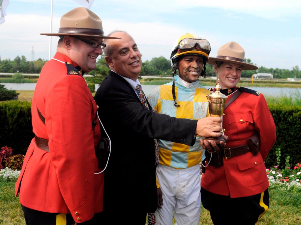 Swift Delivery trainer Mark Casse (second from left) during a 2012 race.