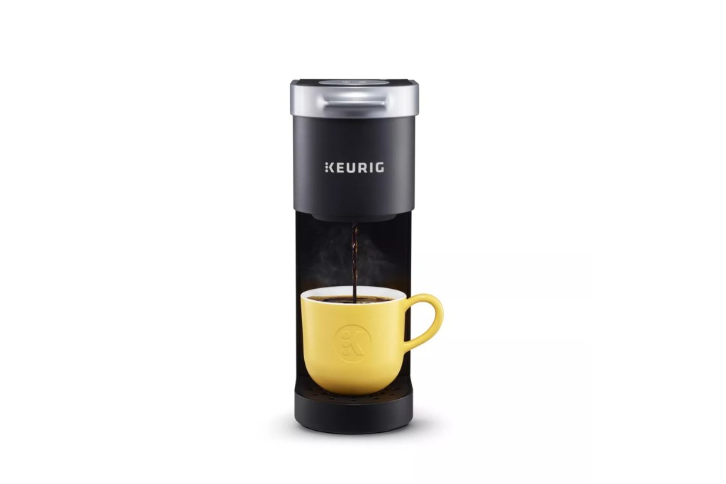 A coffee maker with a yellow cup