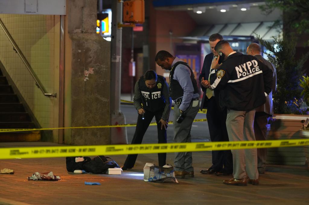 A photo of cops probing a May 8 stabbing on the 7 subway line.