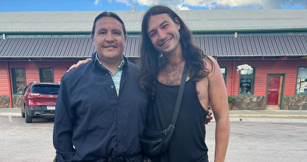 Native American activist Chase Iron Eyes and actor Ezra Miller smiling together