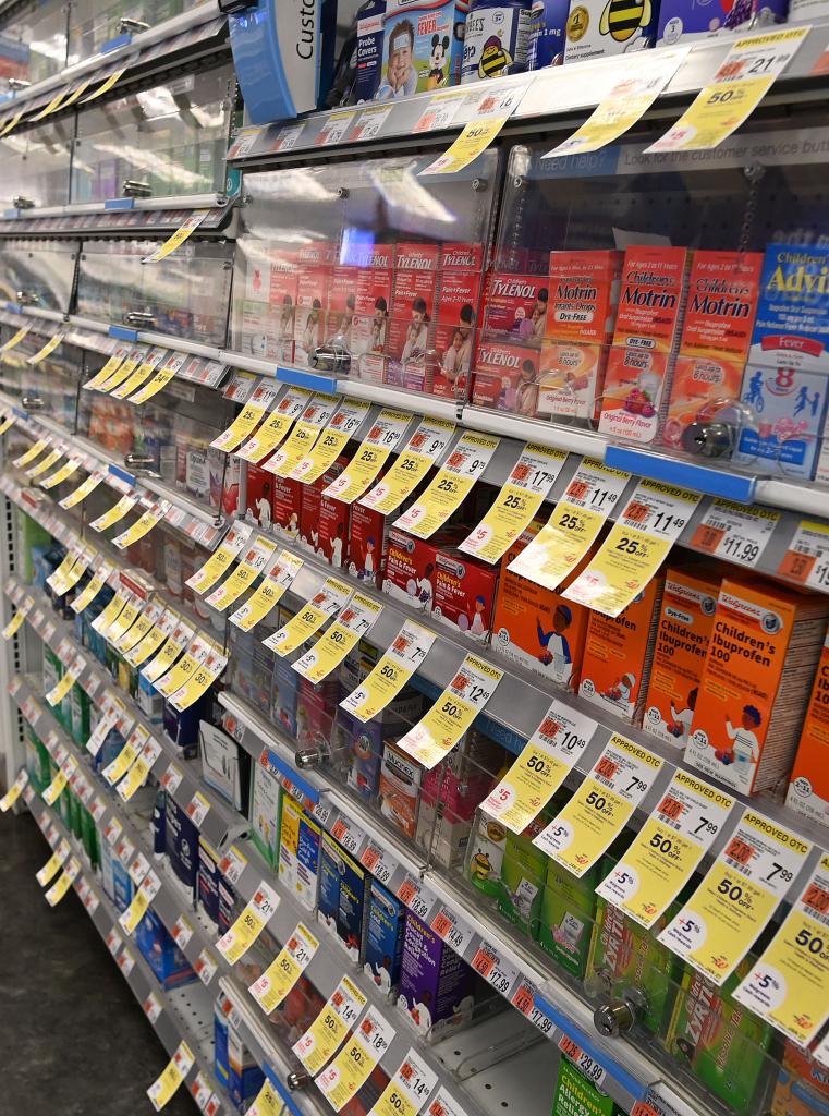 Shelves with locked merchandise at Duane Reade drugstore in Chelsea, New York, due to high theft rates.