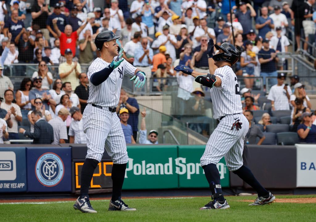 New York Yankees designated hitter Giancarlo Stanton celebrating with center fielder Aaron Judge after hitting a 3-run homer in a game against Cleveland Guardians at Yankee Stadium.