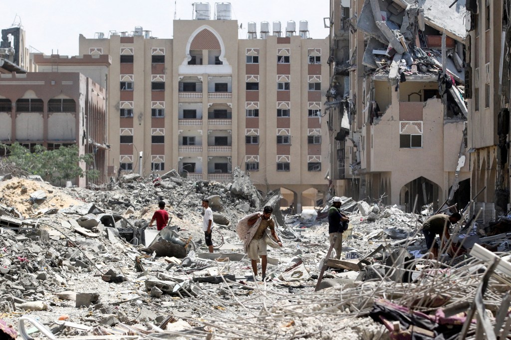 Palestinians comb through rubble in Hamad City, following an Israeli raid.