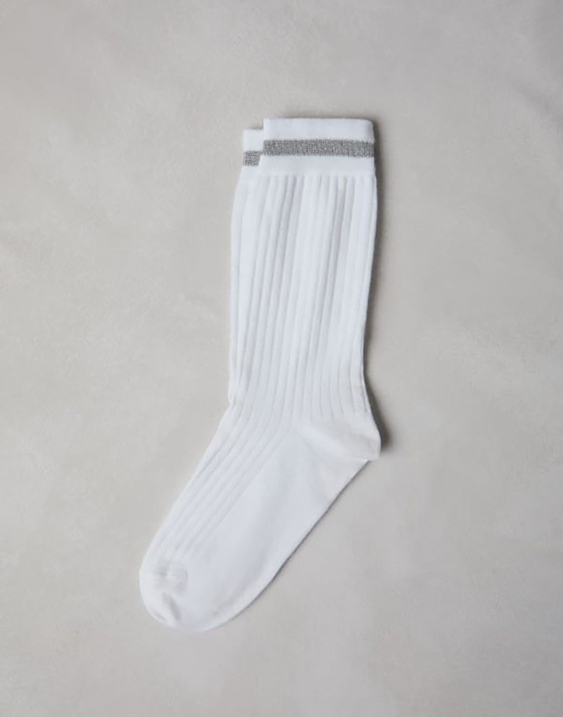 A white ribbed cotton sock on a white surface