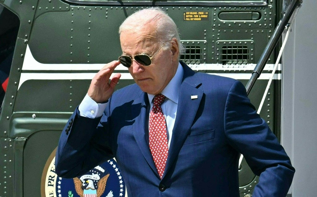 US President Joe Biden in a suit and tie, arriving at Delaware Air National Guard Base on August 2, 2024, for a weekend trip to Wilmington