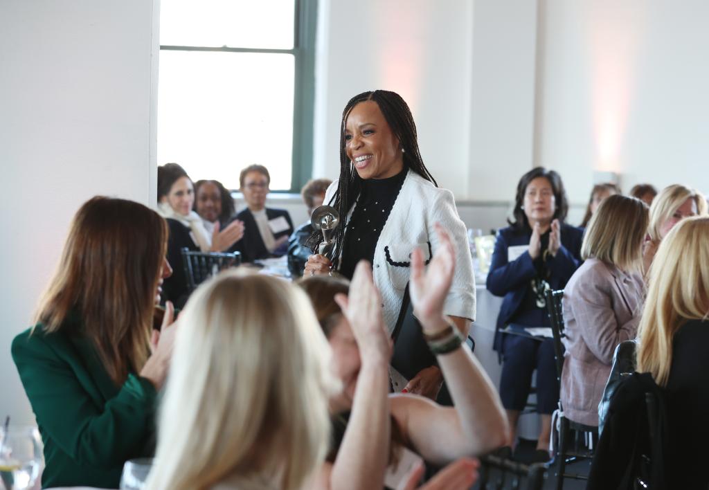 Kim Godwin, President of ABC News, holding a microphone at the Gracies Leadership Awards presented by the Alliance for Women in Media in New York City