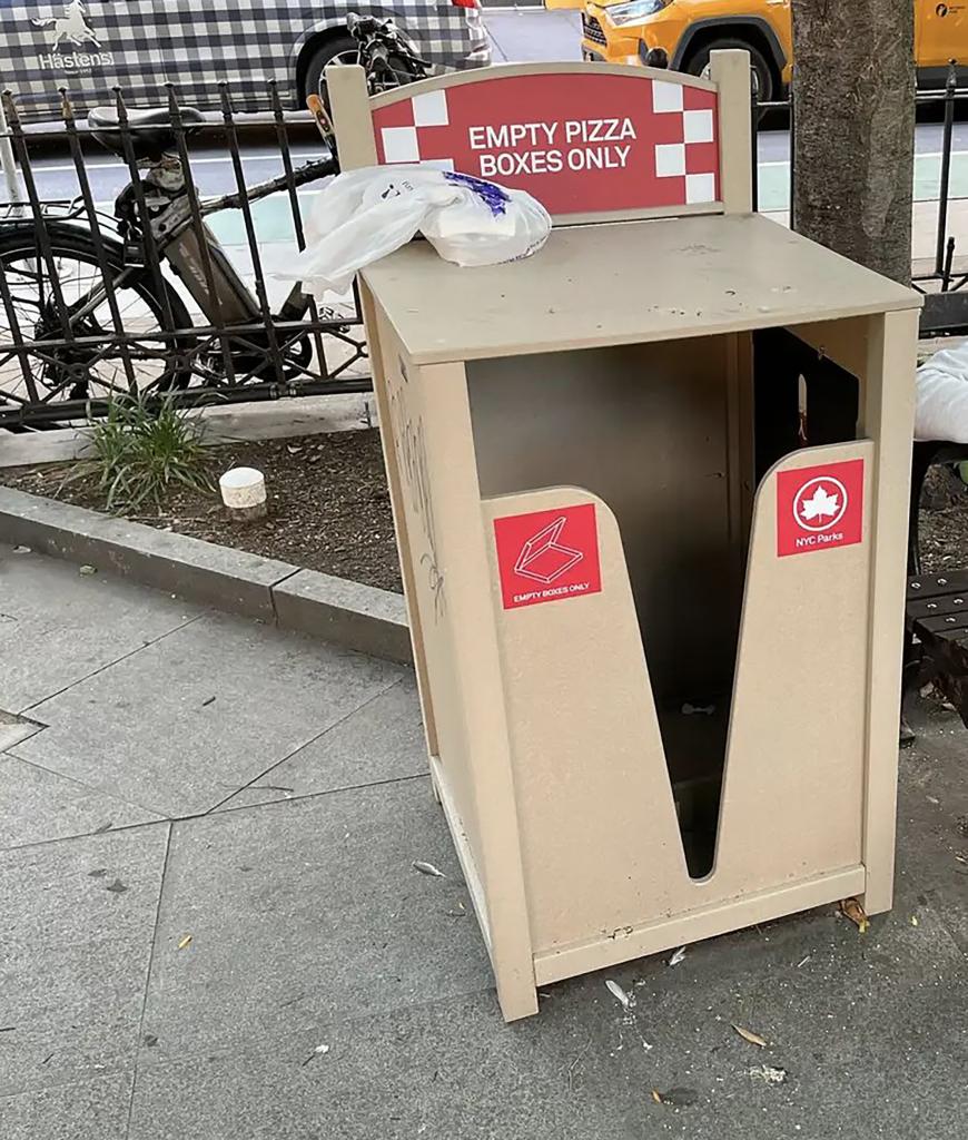 Specialized trash bins in New York City to be filled with stacked pizza boxes.