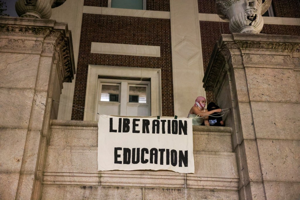 Protesters hang banners on the exterior of Hamilton Hall building after barricading themselves inside the building at Columbia University, after an earlier order from university officials to disband the protest encampment supporting Palestinians, or face suspension, during the ongoing conflict between Israel and Hamas, in New York City, U.S., April 30, 2024