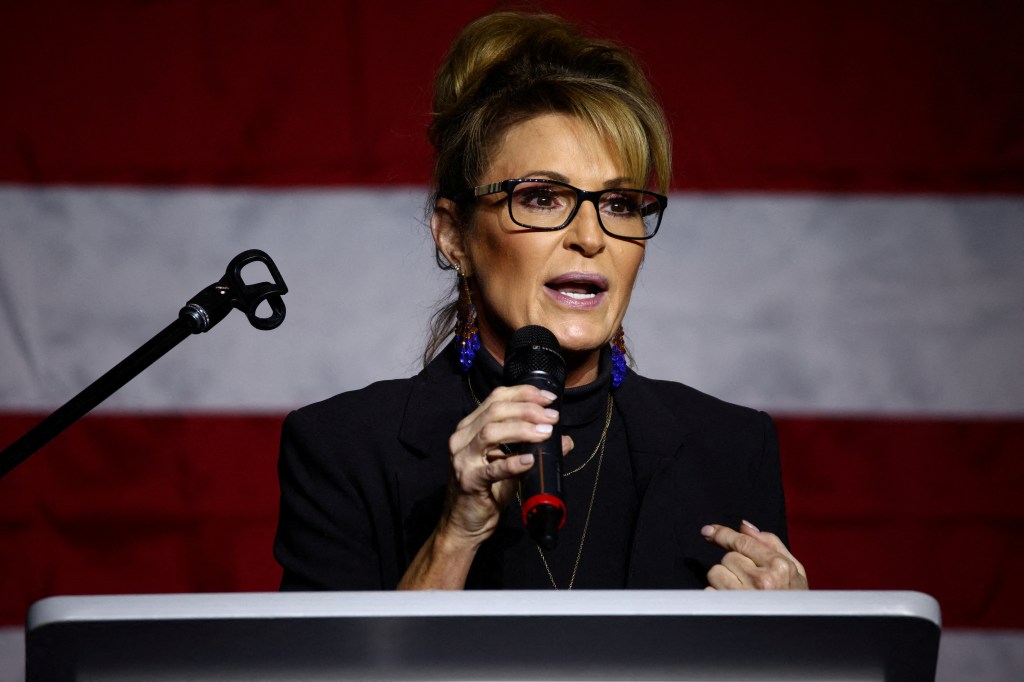 Sarah Palin, Republican candidate for the U.S. House of Representatives, speaking into a microphone at a campaign event in Anchorage, Alaska on October 9, 2022.