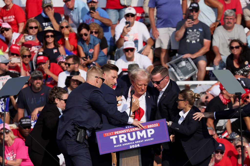 Trump was assisted by U.S. Secret Service personnel after gunfire rang out during a campaign rally on July 13, 2024. 